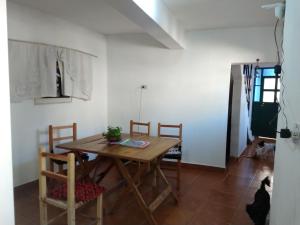 een eetkamer met een houten tafel en stoelen bij EL HOSTELITO in Iruya
