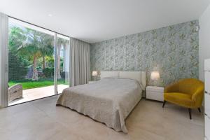 a bedroom with a bed and a chair and a window at Villa Abama in Tejina de Isora +61 photos