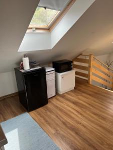 a kitchen with a stove and a window at Amelie's House in Rajcza