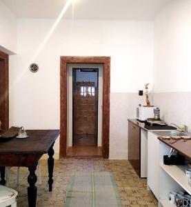 a kitchen with a door in the middle of a room at Family Apartman Szádelő - Zádiel in Zádiel