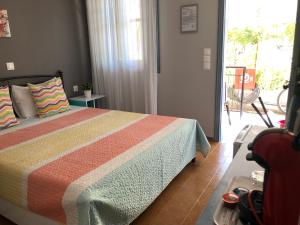 a bedroom with a bed and a view of a patio at Kakovatos Studios in Zacharo