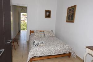 1 dormitorio con 1 cama en una habitación blanca en Hermes Apartment -1 en Nafplio