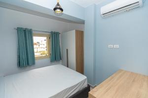 a small bedroom with a bed and a window at Villa The Old Bakery in Qeparo