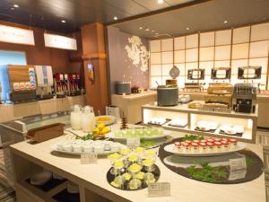 a kitchen with a buffet of food on a counter at LiVEMAX RESORT Aki Miyajima in Miyajima