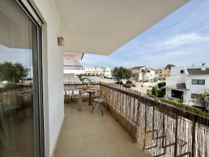 a balcony with a table and a view of a street at Alvor Brightness by Homing in Alvor