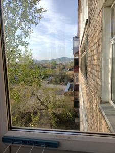 a window of a building with a view of a field at Квартира в районе жд вокзала in Shchūchīnsk