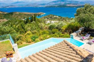 a villa with a swimming pool and a view of the ocean at Villa Aloni Sinies in Ágios Stéfanos