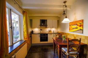 a kitchen with a table and a dining room at Unique Courtyard House with Sauna in Alkmaar city center in Alkmaar