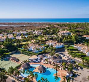 an aerial view of a resort with a pool and the ocean at Encosta do Lago - With Private Pool in Quinta do Lago