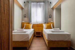 Posteľ alebo postele v izbe v ubytovaní Zoe Suites