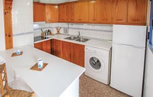 a kitchen with a white refrigerator and a washing machine at Apartamento Argentina by Rental Olé in El Moncayo +14 photos