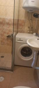 a bathroom with a shower and a toilet and a sink at Happiness Apartment Center in Bitola +16 photos