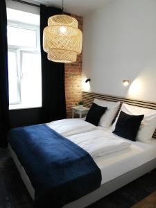 a bedroom with a large bed with a blue blanket at Rooms by Apartamenty Lubartowska Street in Lublin