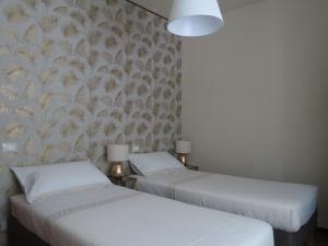 two beds sitting next to each other in a room at La Corticella in Lucca +20 photos