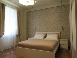 een slaapkamer met een groot bed met een muur bij La Corticella in Lucca