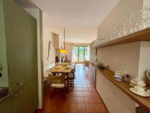 a kitchen and dining room with a table and chairs at Villa Martina in Begur