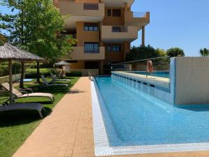 a swimming pool in front of a building at Sotogrande Ribera Marlin in Sotogrande