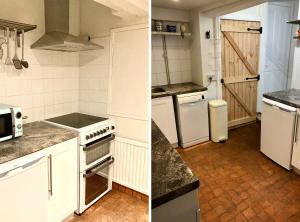 a kitchen with white cabinets and a stove top oven at The Garden Cottage in Stroud