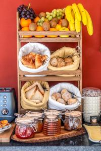 a shelf filled with different types of bread and fruit at Lisbon Wine House - Rooms & Suites in Lisbon