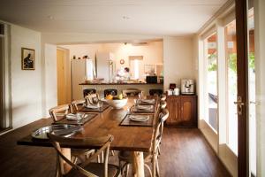 a dining room with a long wooden table and chairs at Arkaba Homestead in Hawker