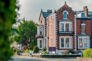 a large red brick house on a street at Rowntree Lodge in Scarborough