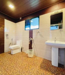 a bathroom with a toilet and a sink at Wild Elephant Resort in Kallar Vattiyar