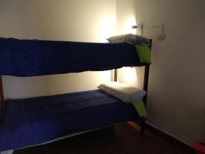 two bunk beds in a room with a smaller bed at EL HOSTELITO in Iruya