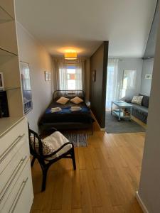 a bedroom with a bed and a living room at Apartament Stella Maris in Puck