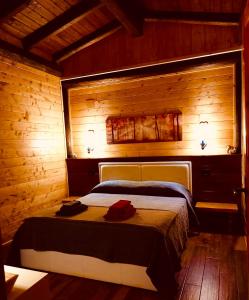 a bedroom with a bed in a wooden room at Chalet Vacanze Il Daino in Leonessa