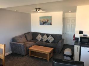 a living room with a couch and a coffee table at Deluxe Kipling Villa with Sea Views in Bideford