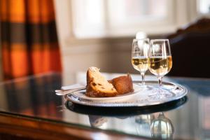 a plate of bread and two glasses of wine at Hotel Suisse in Strasbourg