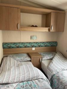 a bedroom with two beds in a small room at Swift bordeaux 24 in Dunoon