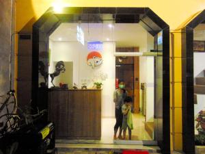 a man and a child standing in a store window at Cabin Hotel Bhayangkara in Yogyakarta