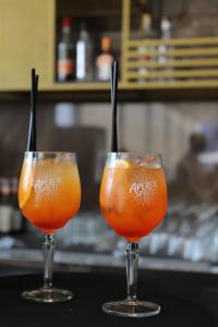 two glasses of orange juice sitting on a table at Hotel Villa Pascucci in Durrës