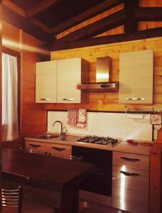 a kitchen with a sink and a stove top oven at Chalet Vacanze Il Daino in Leonessa