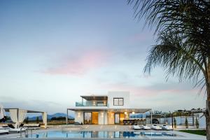 a house with a swimming pool and a villa at Alma Villa, 2000m2 Luxury Living, by ThinkVilla in Angeliana