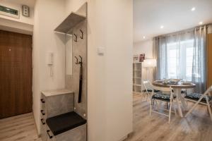 a kitchen and dining room with a table and chairs at 06 Gdynia Centrum - Apartament Mieszkanie dla 4 os in Gdynia