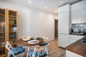 a kitchen with a small table and chairs in a kitchen at 06 Gdynia Centrum - Apartament Mieszkanie dla 4 os in Gdynia
