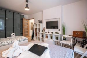 a bedroom with two beds and a tv and a table at 06 Gdynia Centrum - Apartament Mieszkanie dla 4 os in Gdynia