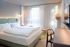 Giường trong phòng chung tại Hotel Indigo Vienna - Naschmarkt by IHG