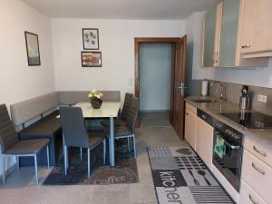 a kitchen with a table and chairs in a room at Apartment Lochner Piesendorf-Walchen in Piesendorf