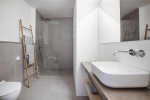a bathroom with a sink and a toilet and a shower at B.Hostel in Comporta