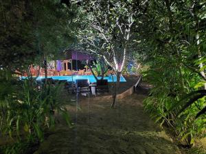 a swimming pool in the middle of a forest at Mealea Resort in Kep