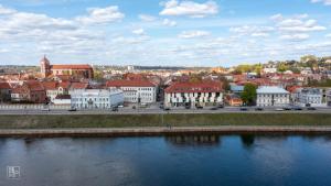 a view of a city with a river and buildings at Kaunas Old Town apartment with underground parking in Kaunas