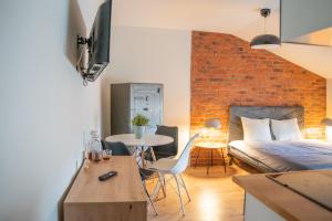 a bedroom with a bed and a table with chairs at Moon Apartments Warszawa in Warsaw