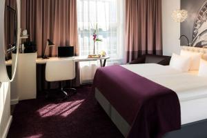 Postel nebo postele na pokoji v ubytování Dorint Kongresshotel Mannheim