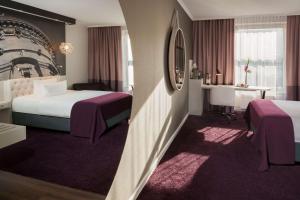 Postel nebo postele na pokoji v ubytování Dorint Kongresshotel Mannheim