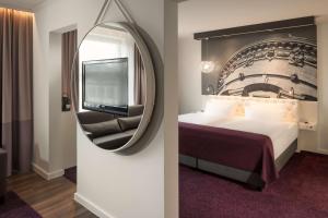 Postel nebo postele na pokoji v ubytování Dorint Kongresshotel Mannheim