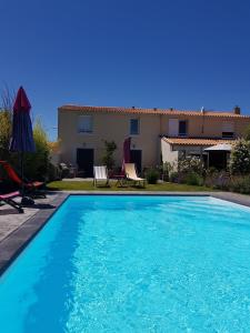a swimming pool in front of a house at La villa 13&15 in Saint-Georges-de-Didonne