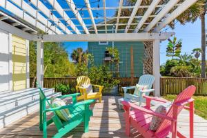 a group of colorful chairs sitting on a patio at 817 E Ashely Ave Pleasant Breeze in Folly Beach